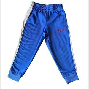 Boy’s Nike 2T blue with a gray strip sweatpants.